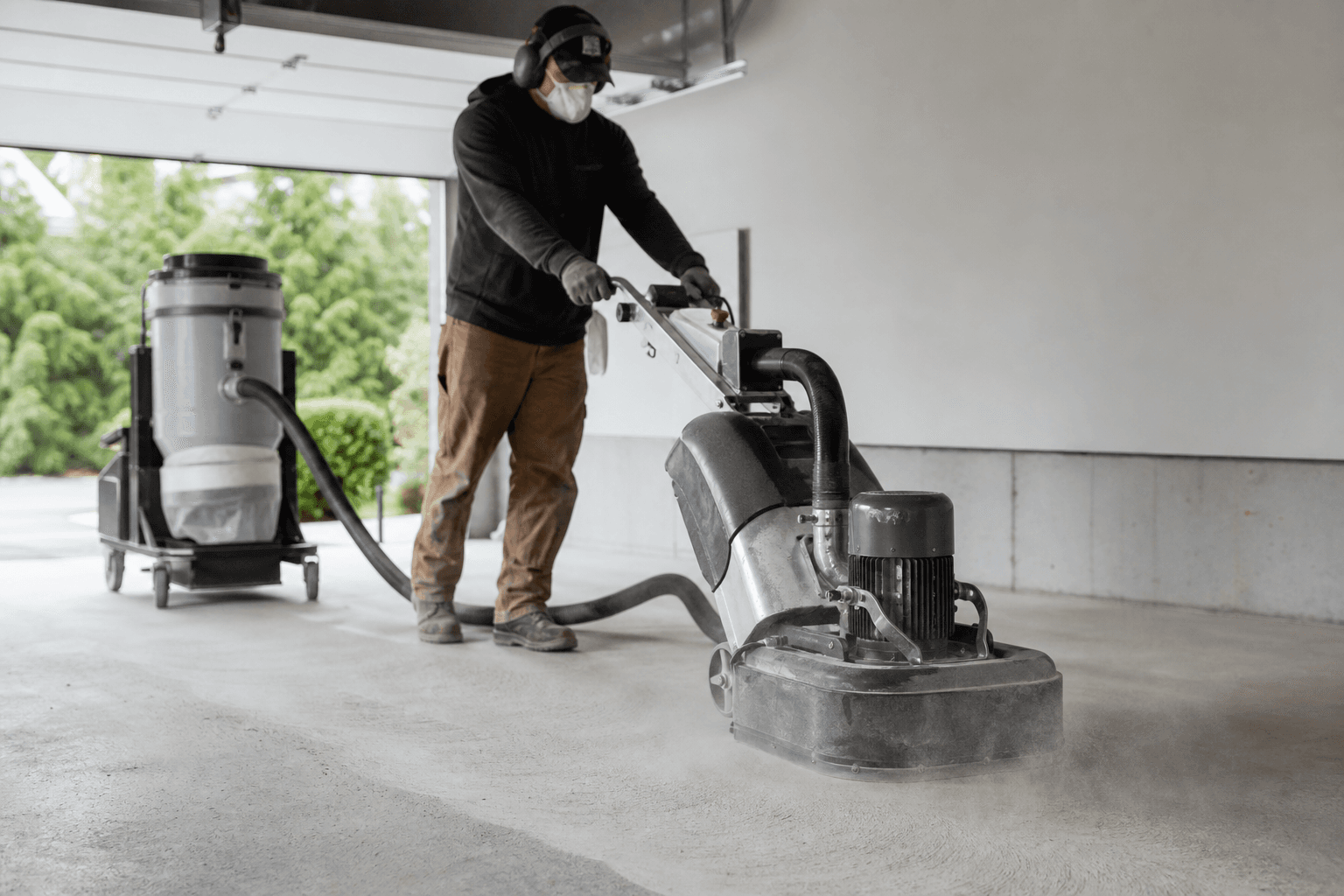 Diamond grinding prep on a Rochester Hills garage slab before epoxy coating