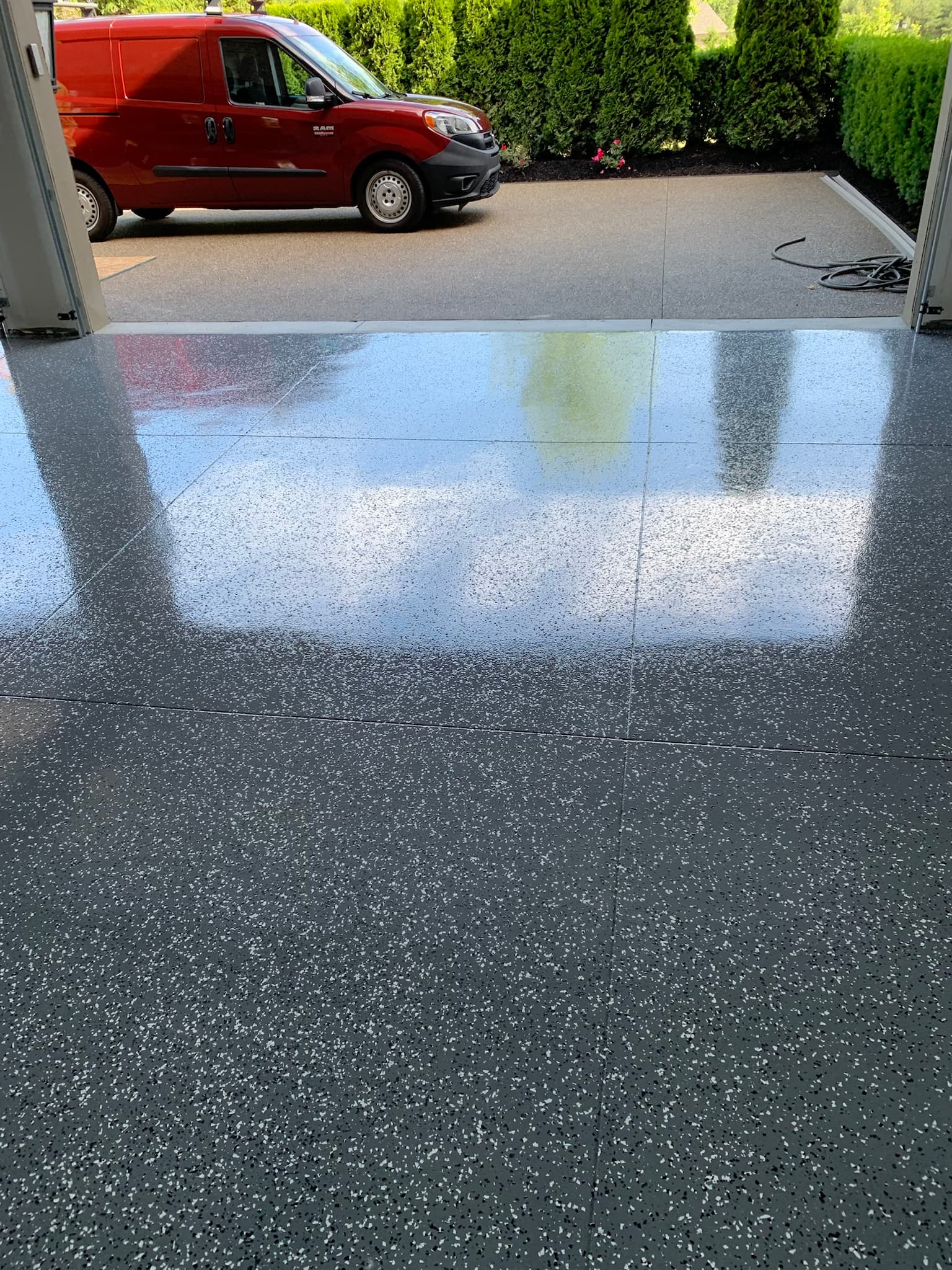 Finished Reserve Coatings garage floor with company work van